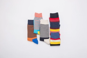 Macro view of assorted colorful striped cotton blend crew socks in various patterns