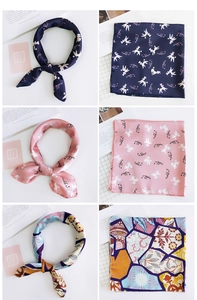 Detail of printed silk neckerchiefs showing cartoon poodle and bohemian floral patterns