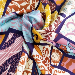 Elegant square silk scarf featuring colorful geometric patterns and retro floral prints