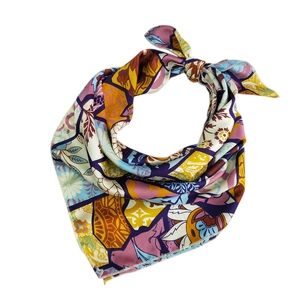 Floral patchwork silk square scarf tied in a stylish knot on a clean white background