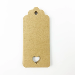 Close-up of brown kraft paper gift tags with heart-shaped cutout and pre-punched hole