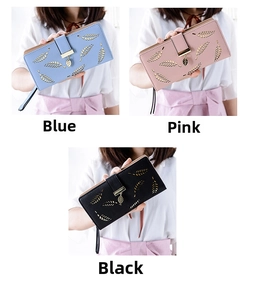 Detailed view of hollow leaf pattern and metal leaf pendant on long leather wallets