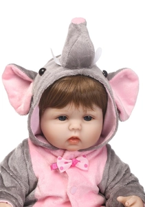 Close-up of lifelike baby doll with blue eyes and elephant hood plush clothing