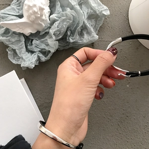 Detail of S925 sterling silver hook closure and black leather rope bracelet for couples