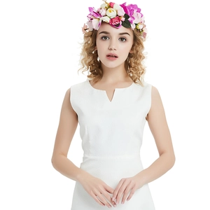 Close-up of a model wearing a pink and white floral rose wreath hair accessory