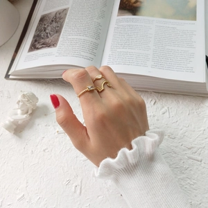 Three-piece gold ring set featuring snake and leaf designs with rectangular zircon detail