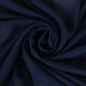 Close-up of dark blue chiffon fabric with smooth texture and elegant spiral draping