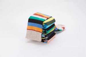Detail view of colorful striped crew socks in premium cotton knit fabric stack
