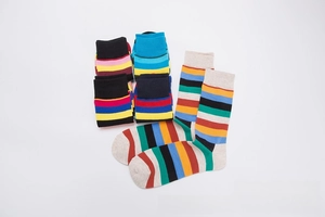 Close-up of colorful striped cotton crew socks with contrasting white heels and toes