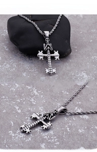 Macro detail of gothic skull cross pendant with clear zircon and retro silver finish