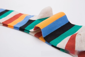 Close-up of rainbow striped cotton blend socks featuring fine knit texture and vibrant colors