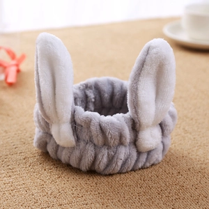 Close-up of a soft grey plush headband featuring cute white bunny ears for skincare