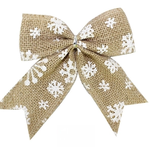 Detail of natural burlap Christmas bow with white snowflake prints for tree decoration