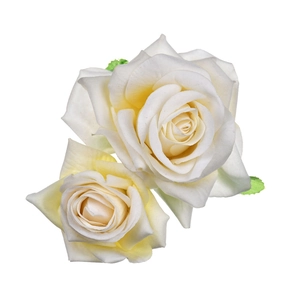 Close-up of dual white velvet rose hair clips with realistic fabric petals and green leaves