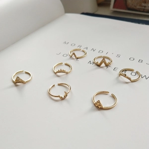 Macro detail of S925 sterling silver stamp on golden geometric adjustable rings