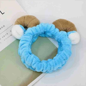 Close-up of soft blue cat ear headband with brown horns for face washing or makeup