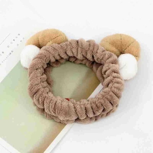 Detailed view of soft brown plush cat ear headband for washing face and styling