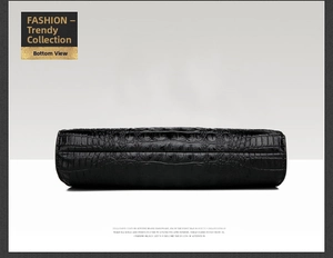 Detailed view of the flat bottom on a black crocodile embossed leather handbag