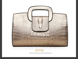 Detail of gold crocodile embossed handbag featuring a unique 3D dragon head sculpture