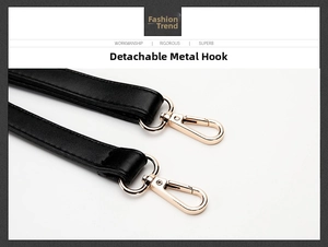 Close-up of detachable black leather shoulder strap with gold metal lobster claw clasp