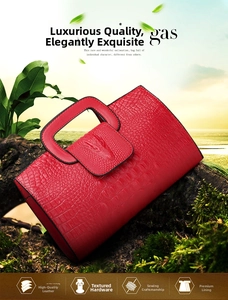 Detailed view of crocodile pattern embossed red handbag with metal hardware details