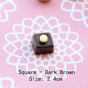 Macro shot of 2.4cm miniature chocolate resin charm with yellow ball detail for DIY