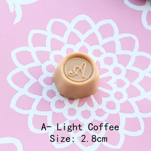 Macro view of 2.8cm light coffee resin chocolate charm with letter A for DIY projects