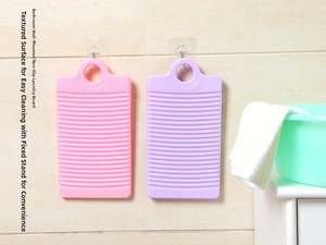 Detail view of mini plastic washboard with anti-slip ridges and convenient hanging hole