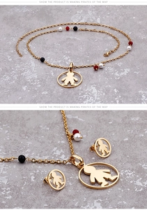 Detail of gold titanium steel jewelry set featuring boy silhouette pendants and beads