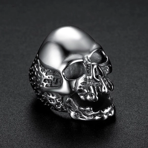 Detailed close-up of a silver punk skull ring with polished metallic finish and dark shadows