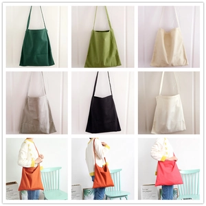 Detailed view of canvas tote bags in multiple colors with lifestyle model demonstration