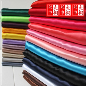 Close-up of colorful silk satin ribbons showing smooth texture and various shiny fabric colors