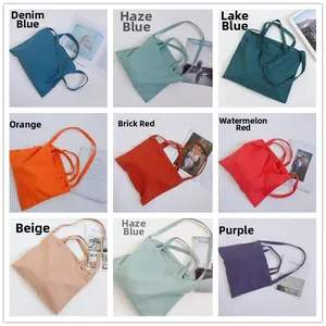 Collage of canvas tote bags in eight solid colors with dual handles and long straps