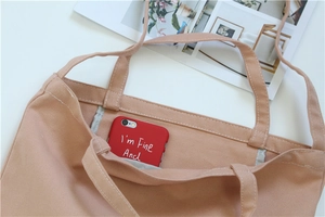 Detailed close-up of pink canvas tote bag showing interior pocket and smooth stitching