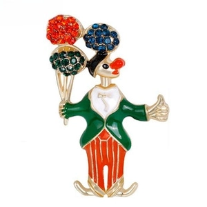 Close-up of circus clown brooch with colorful rhinestones and enamel details on gold alloy