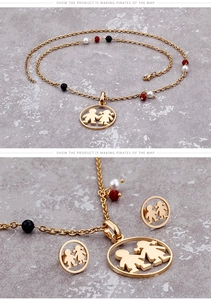 Detail view of gold-tone necklace and studs set with boy girl motif and colored beads