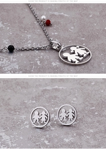 Detailed view of silver stainless steel jewelry set with boy and girl cut-out patterns
