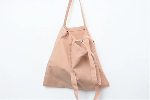 Close-up of a minimalist light pink canvas tote bag with natural fabric texture