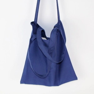 Detail of minimalist navy blue canvas tote bag showing the textured fabric and sturdy straps