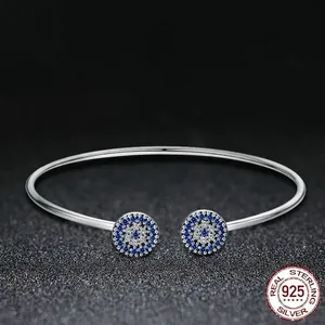 Sparkling S925 sterling silver open bangle featuring evil eye charms and blue zircon stones