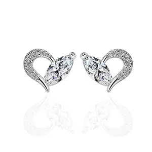 Elegant heart-shaped zircon stud earrings in silver metal with sparkling white center stones
