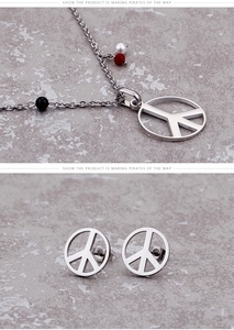 Detailed view of silver peace sign jewelry set with colorful accent beads on stone surface
