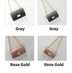 Detail of grey and rose gold quilted chain bags with V-pattern texture and gold hardware
