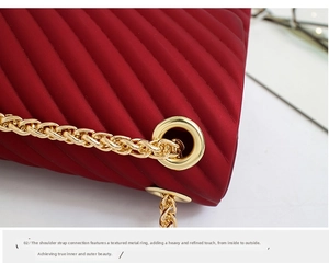 Detail of red quilted matte bag with gold chain link and metallic hardware buckle