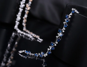 Macro view of blue oval gemstones and sparkling cubic zirconia on silver link bracelet