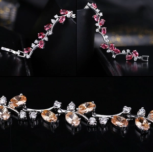 Detail showing oval-cut pink and champagne zircon stones with white diamond accents on silver bracelet
