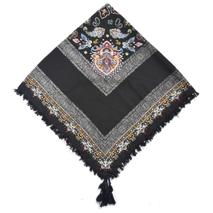 Detail view of black Bohemian square scarf with colorful paisley patterns and knotted tassels