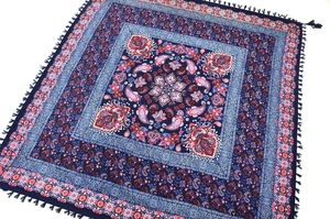 Detail of blue paisley pattern jacquard scarf featuring intricate ethnic knotted tassels