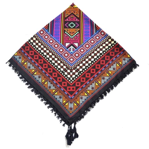 Detail view of Bohemian square scarf with ethnic geometric patterns and black tassels