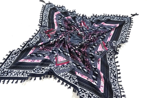 Detailed view of bohemian square scarf with dark blue paisley print and tassel edges